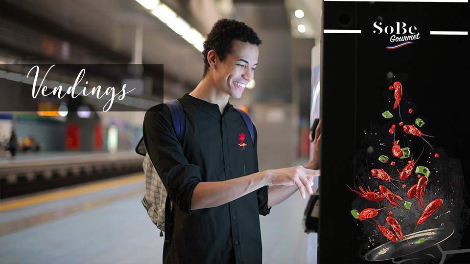 Man ordering food on a vending machine from Sobe-gourmet
